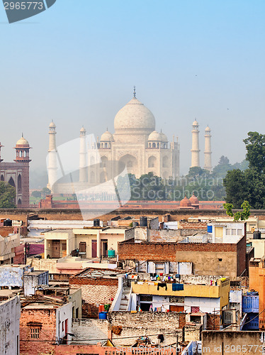 Image of Poor neighborhoods and luxurious Taj Mahal. Agra, India