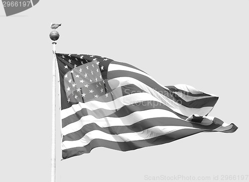 Image of The American flag flies on a sunny day against a clear sky