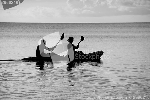 Image of Kayakers silhouetted on the ocean