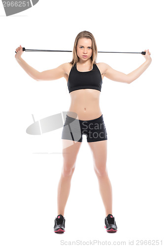 Image of Young woman standing with expander