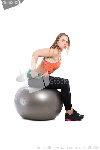 Image of Young blonde training with dumbbells