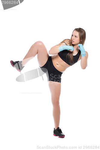 Image of Young woman posing and kicking