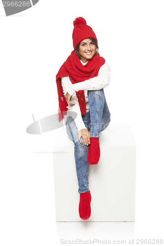 Image of Winter woman sitting on blank billboard placard sign