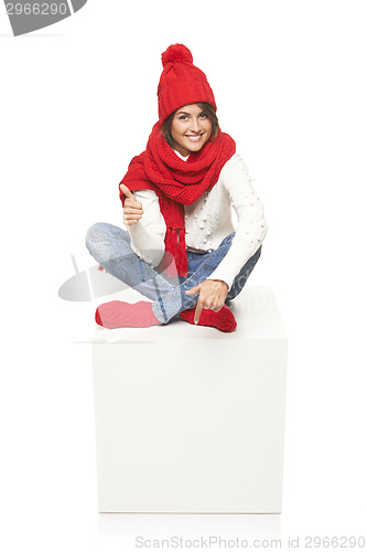 Image of Winter woman sitting on blank billboard placard sign