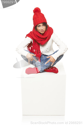 Image of Winter woman sitting on blank billboard placard sign
