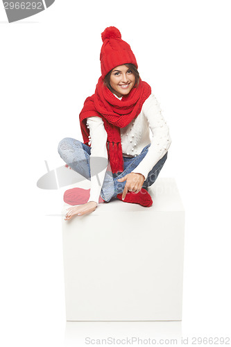 Image of Winter woman sitting on blank billboard placard sign