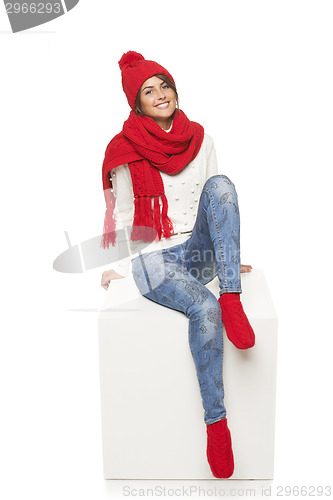 Image of Winter woman sitting on blank billboard placard sign