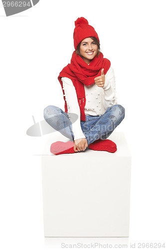 Image of Winter woman sitting on blank billboard placard sign