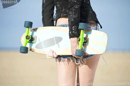 Image of Woman holding Skateboard