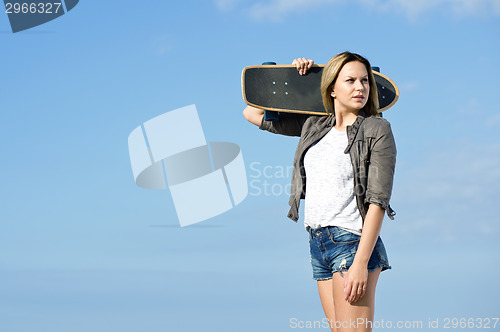 Image of Skateboarding girl looking back
