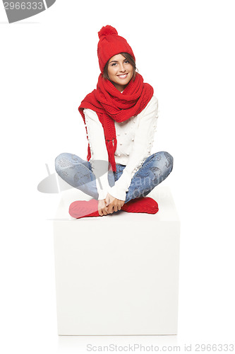 Image of Winter woman sitting on blank billboard placard sign