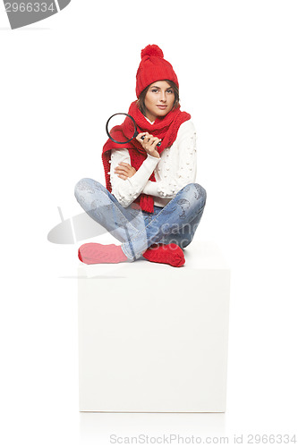 Image of Winter woman sitting on blank billboard placard sign