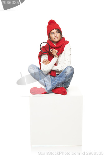 Image of Winter woman sitting on blank billboard placard sign