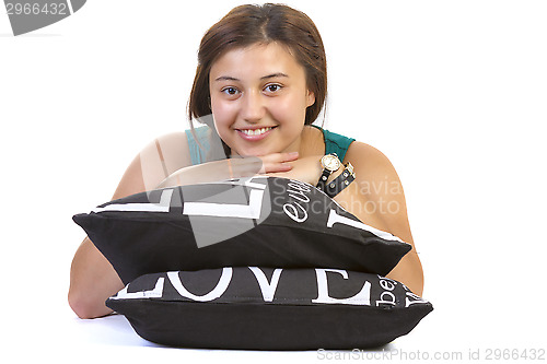 Image of Teenage girl lying over pillows 