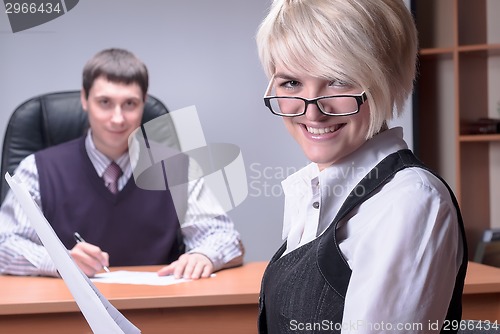 Image of Young and smiling business lady in office