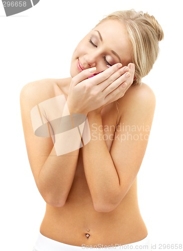 Image of happy blond with red flowers in spa