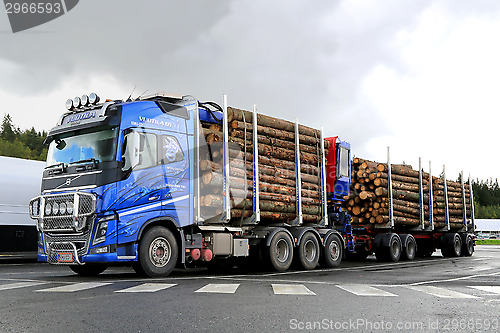 Image of Blue Volvo FH16 700 Timber Truck with Log Trailer