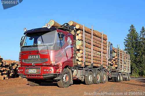 Image of Red Sisu 18E630 Timber Truck Ready to Unload Logs