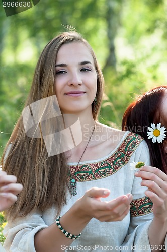Image of Beautiful brunette woman with camomile