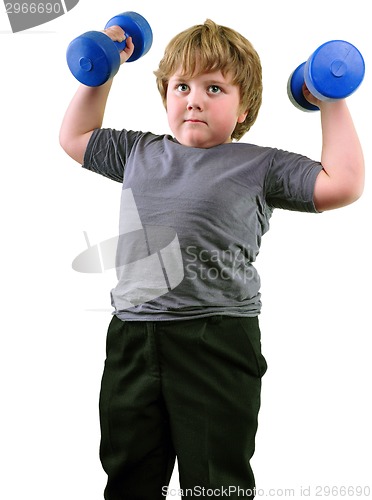 Image of isolated portrait of elementary age boy with dumbbells exercising 