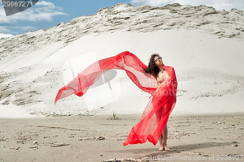 Image of Attractive naked girl on sand