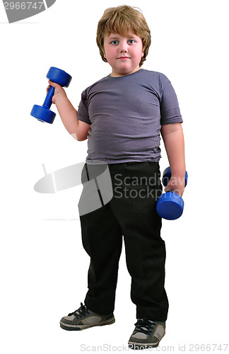 Image of isolated portrait of elementary age boy with dumbbells exercising 