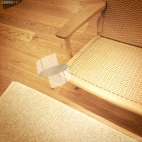 Image of Rattan chair on wooden floor