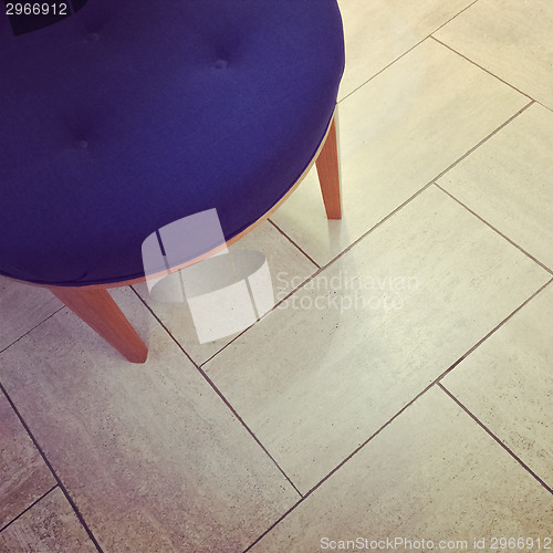 Image of Blue stool on tile floor