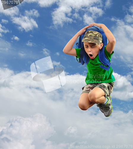 Image of worried or scared schoolchild with backpack against sky