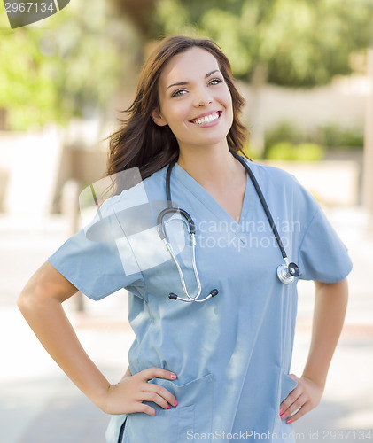 Image of Proud Young Adult Woman Doctor or Nurse Portrait Outside