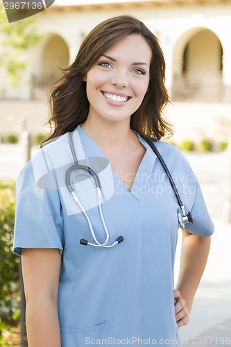 Image of Proud Young Adult Woman Doctor or Nurse Portrait Outside