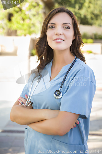 Image of Proud Young Adult Woman Doctor or Nurse Portrait Outside