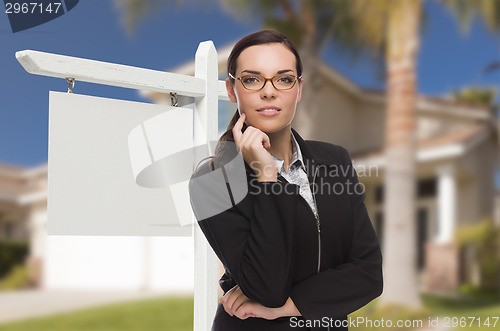 Image of Woman In Front Of House and Blank Real Estate Sign