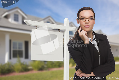 Image of Woman In Front Of House and Blank Real Estate Sign
