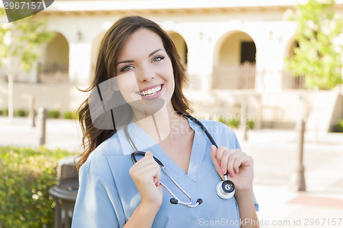 Image of Proud Young Adult Woman Doctor or Nurse Portrait Outside