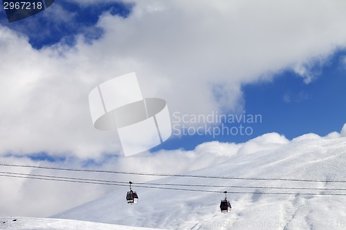 Image of Gondola lifts and off-piste slope at sun day