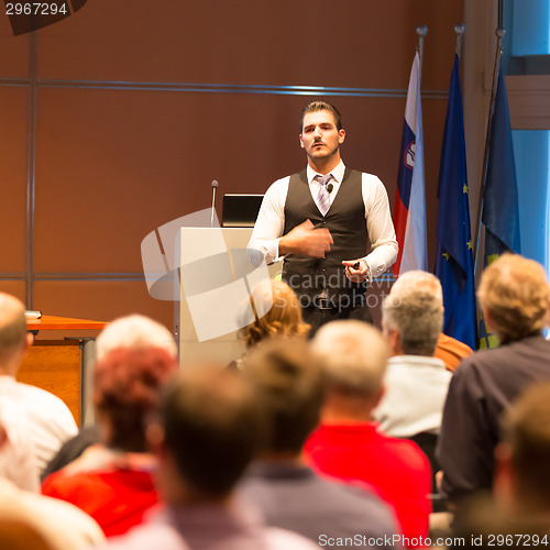 Image of Speaker at Business Conference and Presentation.