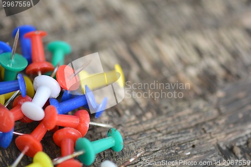 Image of old push pins set on old wooden background