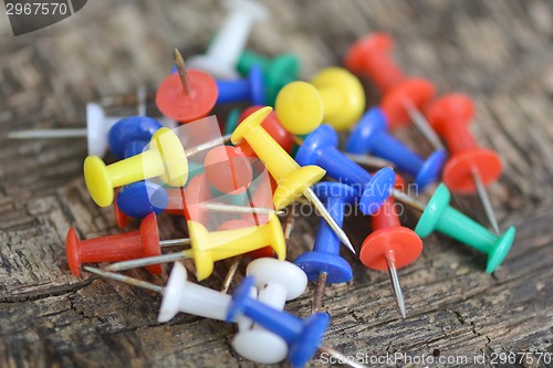 Image of old push pins set on old wooden background