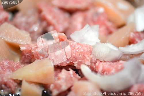 Image of raw meat with onion on the plate