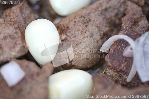 Image of macro food, garlic on fried liver