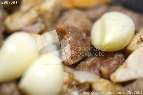 Image of macro food, garlic on fried liver