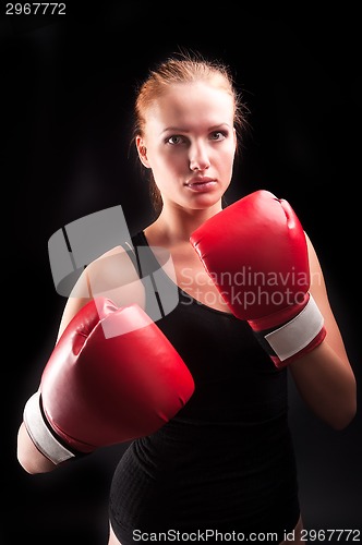 Image of Beautiful girl defends in boxing gloves