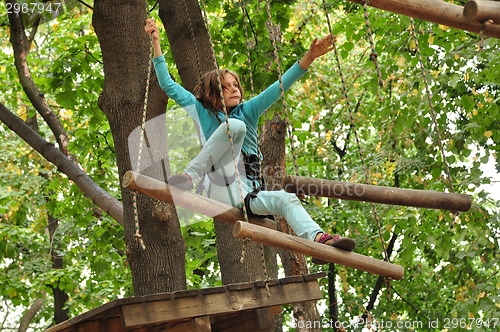 Image of girl  in a climbing adventure activity park