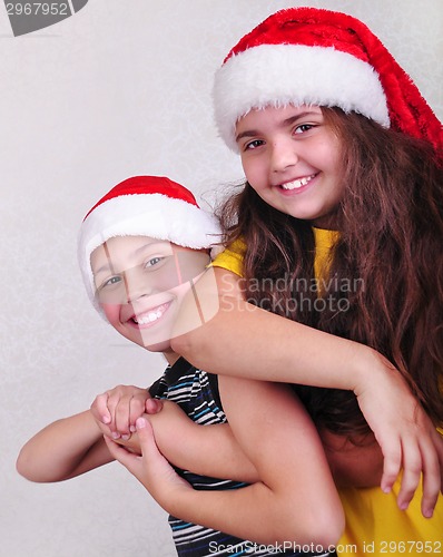 Image of happy children with Santa Claus red hats