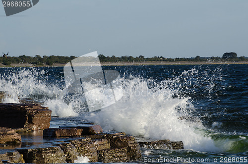 Image of Flat rock coast with splashing water