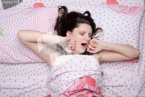 Image of Girl waking yawns and stretches