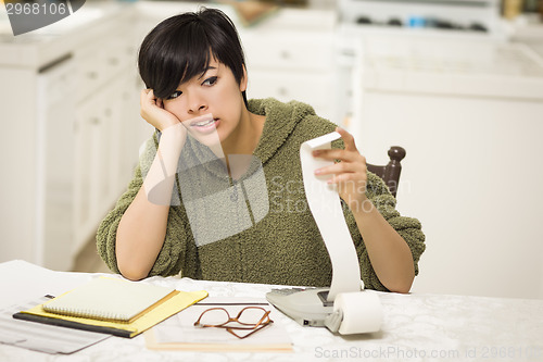 Image of Multi-ethnic Young Woman Agonizing Over Financial Calculations