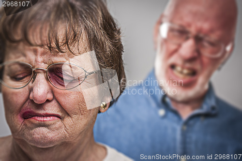 Image of Battered and Scared Woman with Ominous Man Behind