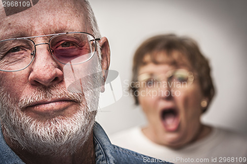 Image of Battered and Scared Man with Screaming Woman Behind